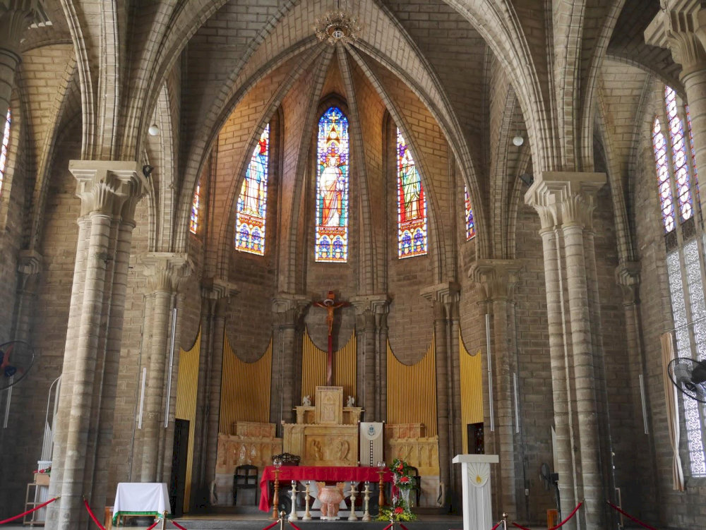 The cathedral's interior is bathed in multicolored light filtered through the stained glass